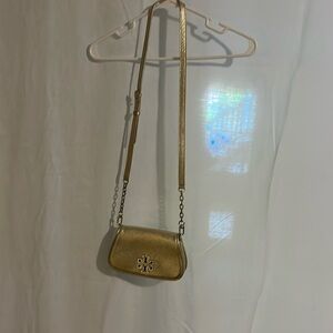 Tori Burch cross over handbag color gold